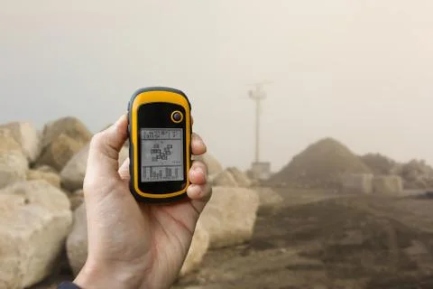 Finding the right position inside a construction site via gps ( blurred backgrou Stock Photos