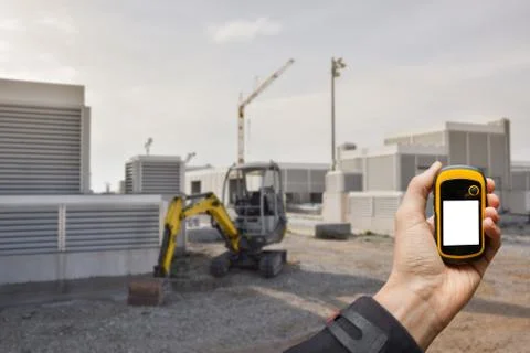 Finding the right position inside a construction site via gps ( blurred bac.. Stock Photos