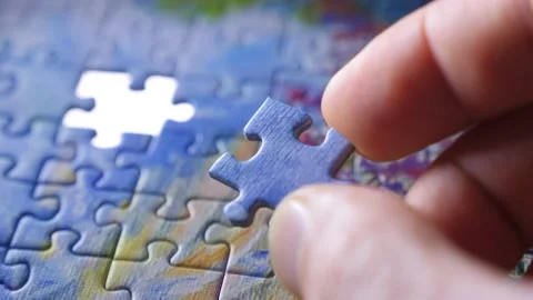 Finding the solution concept. Hand matching jigsaw halves. Leisure activity Stock-Footage 133662369