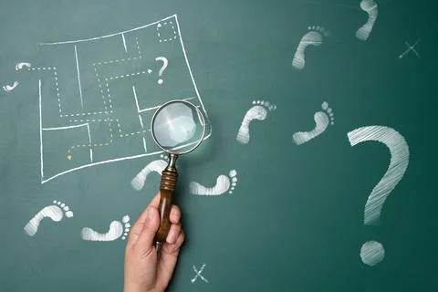 Finding a way out of a difficult situation, a hand with a magnifying glass .. Stock Photos