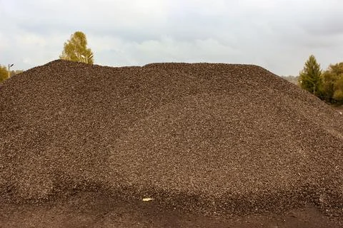 Fine charcoal for heating is dumped in a big pile Stock Photos