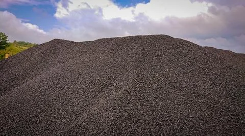 Fine charcoal for heating is dumped in a big pile Stock Photos