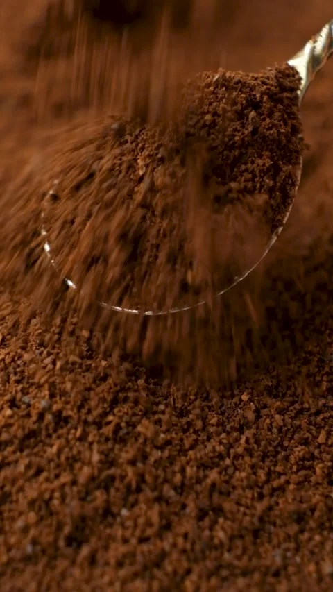 Fine coffee grounds falling onto a spoon in macro view. Stock Footage 344041016