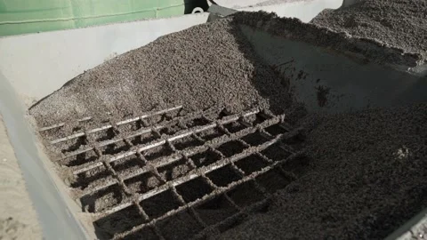 Fine crushed stone in the gutter of the shale shaker. Slow motion Stock Footage 200869356