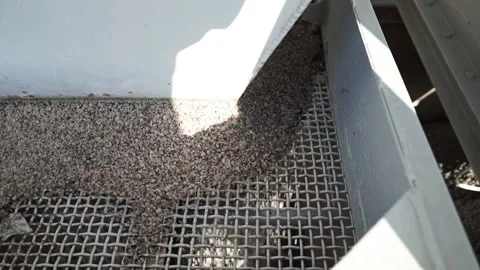 Fine crushed stone in the gutter of the shale shaker. Slow motion Stock Footage 200869400