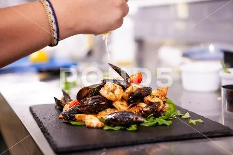 Fine cuisine with seafood on black stone in restaurant kitchen Stock-Fotos
