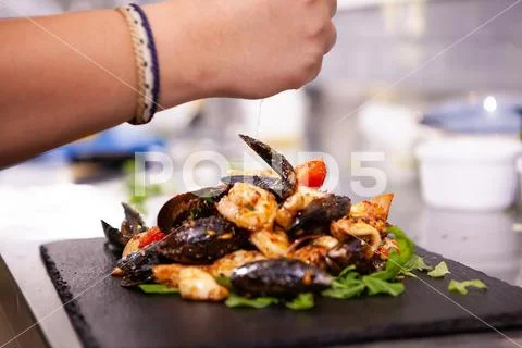 Fine cuisine with seafood on black stone in restaurant kitchen Stock-Fotos