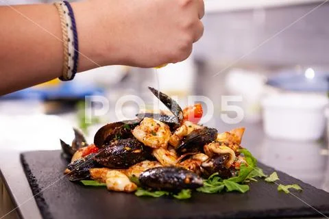Fine cuisine with seafood on black stone in restaurant kitchen Stock-Fotos