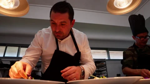 Fine dining: courses being carefully prepared in the kitchen by the chef. Stock Footage 325328782