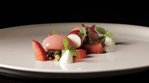 Fine dining dessert turning aroud in black background Stock Footage 68965553