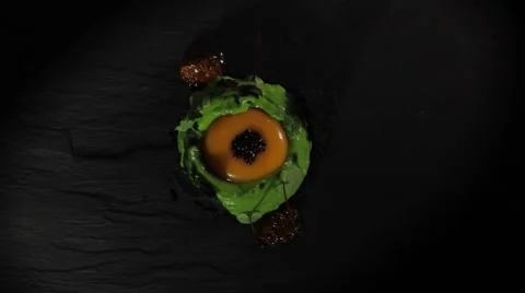 Fine dining dish turing around in granite plate from top view Stock Footage 68965291