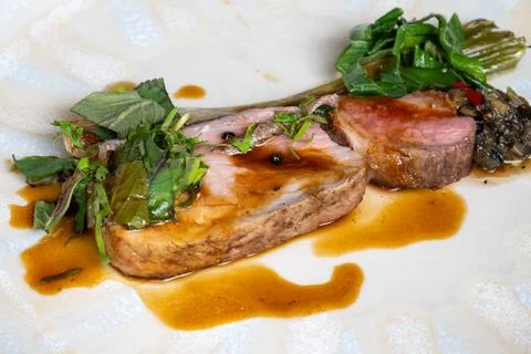 Fine dining in restaurant with chef, main dish pork, sauce, grilled leek, f.. Stock Photos