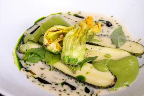 Fine dining in restaurant with chef, main vegetarian dish with young zucchi.. Stock Photos