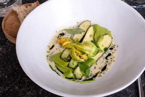 Fine dining in restaurant with chef, main vegetarian dish with young zucchi.. Stock Photos