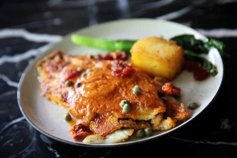 Fine dining Seabass fillets with tomato and spices sauce Stock Photos