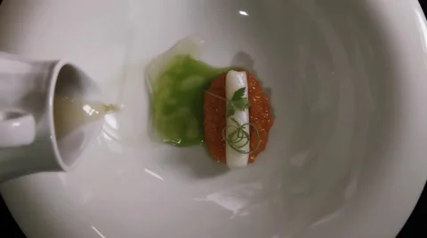 Fine dining soup dish being served in an overhead shot Stock Footage 68964996