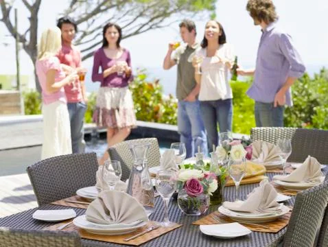 Fine Dining Table Setting With Friends In Background Stock Photos
