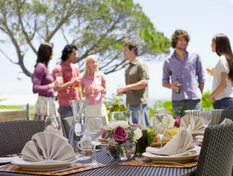 Fine Dining Table Setting With Friends In Background Stock Photos
