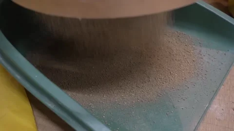 Fine Dry Soil Falling Through a Sieve into a Tray Stock Footage 340901120