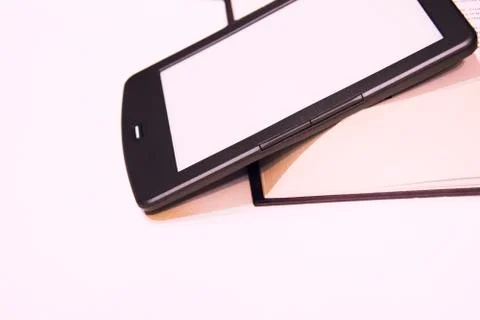 Fine e-book next to a thick paper book. Stock Photos