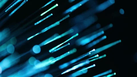 Fine fiber optic tips emitting neon purple, cyan, and green light in darkness. Stock Footage 342764421