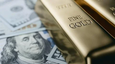 Fine Gold Bars Resting on US Dollar Banknotes. 3d rendering Stock Photos