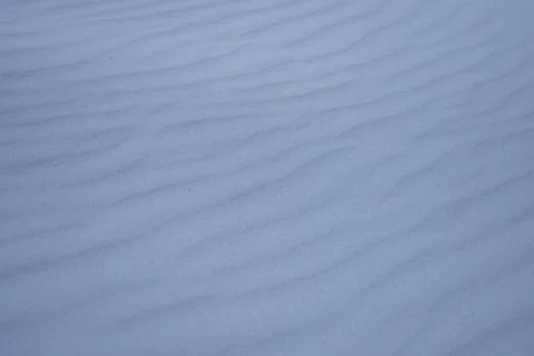 Fine-grained rippled sand surface is stretching diagonally in close-up dune Stock Photos