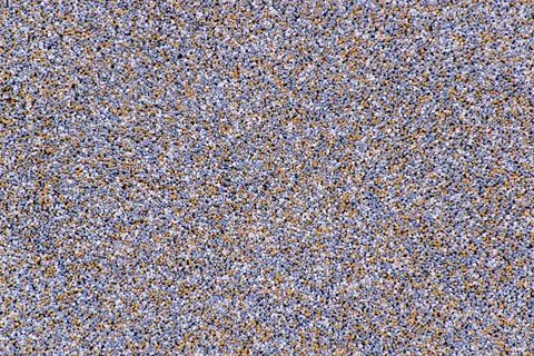 Fine-grained surface of the surface of tiny stones. Stock Photos