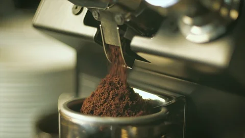 Fine ground coffee beans grinder machine into holder in slow motion Stock Footage 103817901