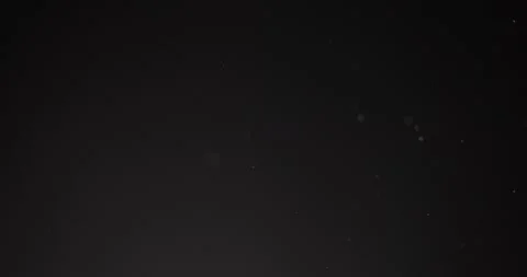 Fine particles flying around against dark background Video stock 156081707