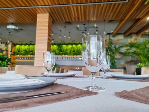 Fine restaurant dinner table place setting,napkin and wineglass.Empty glasses Stock Photos