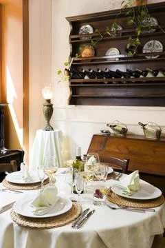 Fine restaurant table setting and wine bottles Stock Photos