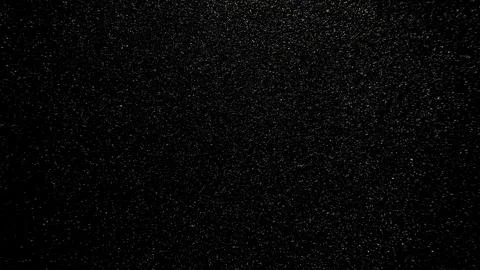 Fine sparkling silver glitter texture shimmering over deep black background w Fotos Stock