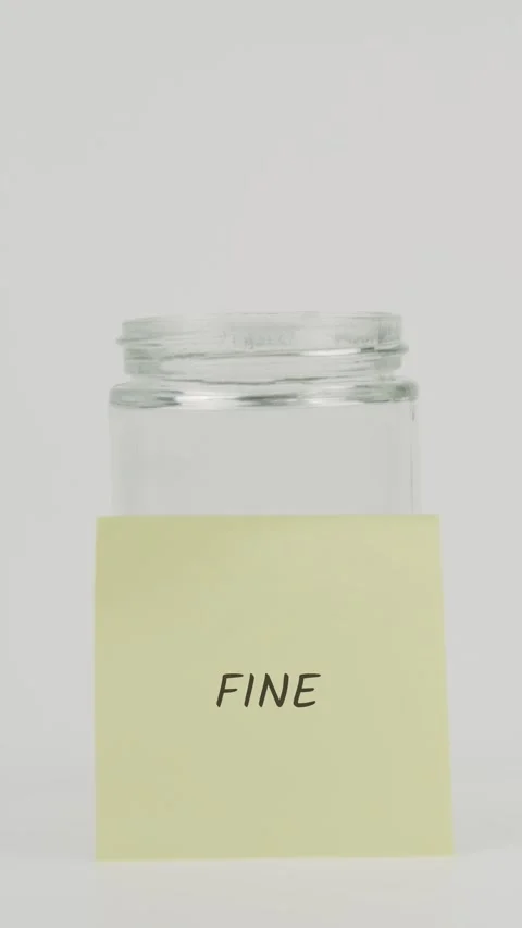Fine text or word on yellow sticky note attached to glass jar with hand Stock Footage 311733720