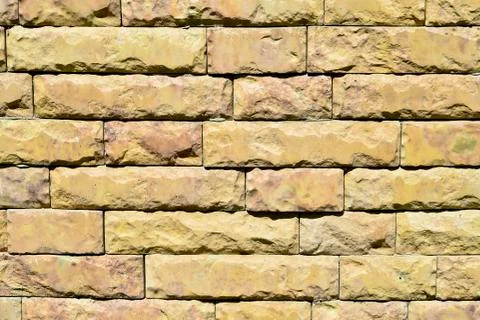 Fine texture of the wall light yellow bricks. Background. Stock Photos