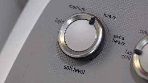 Fine-Tuning Soil Settings: Hand Adjusting Washing Machine's Soil Knob Stock Footage 264639573