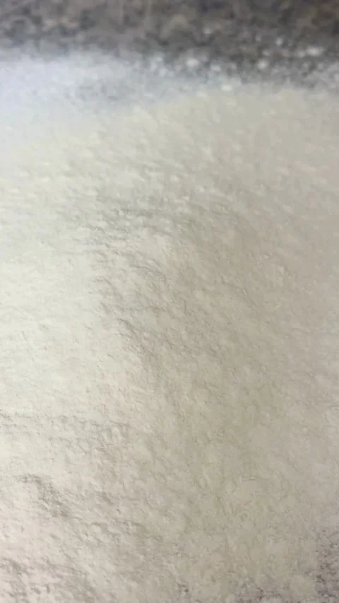 Fine white flour powder being poured onto a surface Stock Footage 331974863