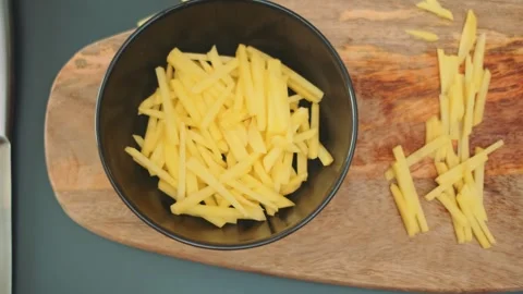 Finely chopped potatoes fall into a deep bowl Stock-Footage 252180614