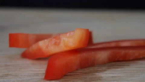 Finely chopped red pepper is poured onto a cutting board closeup. Macro view Stock Footage 160655870