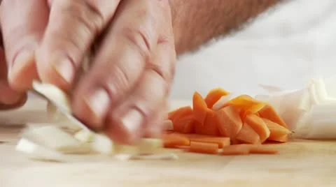 Finely chopped vegetables being put in a bowl Stock Footage 24635053