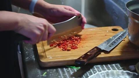 Finely Chopping Red Chili Pepper for Cooking Stock Footage 346487626