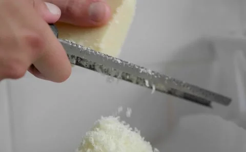 Finely Grating Parmesan Cheese Slowmo Stock Footage 139232694