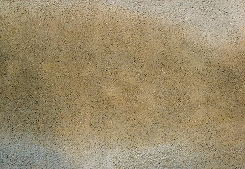 Finely structured beige surface with small tufts of sand 写真素材