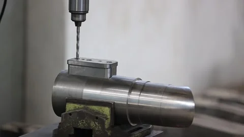 Finesse of manual drilling as operators transform metal pieces into Stock Footage 250070439