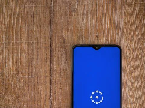 Fing app launch screen on smartphone on wooden background Stock Photos