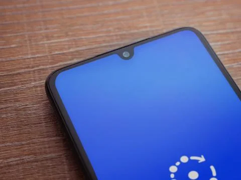 Fing app launch screen on smartphone on wooden background Stock Photos