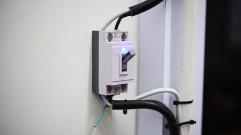 Finger is about to switch off on an RCD circuit breaker board Stock Footage 97578294