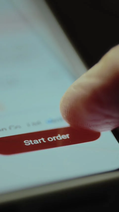 Finger about to tap the red Start order button in an online shopping application Stock Footage 327899893