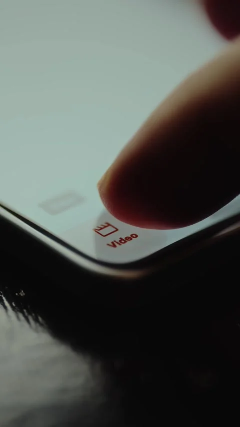 Finger about to tap the Video button on a mobile phone screen Stock Footage 327523842