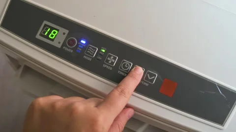 Finger Adjusting Temperature on Digital Portable Air Conditioner Panel Stock Footage 342278222